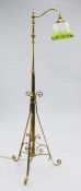 An Edwardian copper and brass adjustable standard lamp, with single scrolling branch, with green