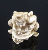 A Japanese walrus ivory netsuke of Shoki crushing two oni, signed Gyokuzan, Meiji period, 3.8cm