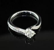 An 18ct white gold single stone diamond ring with diamond set shoulders, in Tolkowsky box, with a