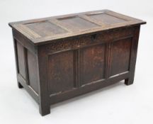 An 18th century oak coffer, with three panel front and stile feet, W.3ft 3.5in.