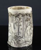 A Japanese ivory brush pot, late 19th century, carved in high relief with three sages and attendants