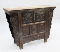 A Chinese elm side cabinet, fitted with an arrangement of five drawers, relief carved with floral