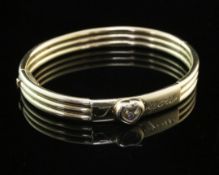 An 18ct gold Chopard "I Love You" hinged bangle, of reeded form, the glazed heart motif set with "