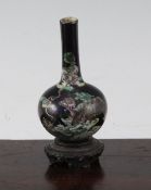 A Chinese miniature famille noire bottle vase, late 19th century, finely painted with lion-dogs amid