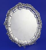 A late Victorian Scottish silver salver, of shaped circular form, with scrolling foliate border,