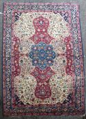 A Tabriz carpet, with central foliate medallion, in a field of scrolling foliage, on a red and ivory