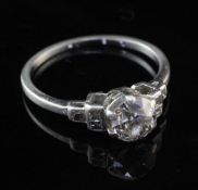 A 1940's/1950's platinum and single stone diamond ring, with square cut diamond set shoulders, the