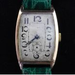 A gentleman's stylish 1920's Swiss 9ct gold manual wind wrist watch, with tonneau shaped Arabic dial