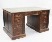 A late Victorian oak desk by Gillow, the top drawer stamped Gillow L1151, with green leather