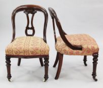 A set of six Victorian mahogany dining chairs, the arched backs with central pierced splat, over-