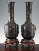 A pair of large Japanese bronze bottle vases, late 19th century, the lobed bodies cast in relief