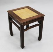 A Chinese rosewood low table or urn stand, the top inset with raffia panel, W.1ft 7in.