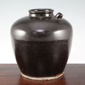 A Chinese Henan ware black glazed ovoid jar, Song dynasty, with short spout to the shoulder,