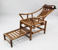 A late 19th/early 20th century provincial Chinese moon gazing chair, with panel back and slide out
