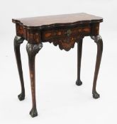 An early 19th century Dutch marquetry inlaid serpentine card table, with fold-over top revealing