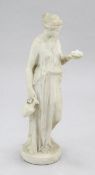 A 19th century carved marble figure of a Grecian woman, standing on a circular base holding a jug