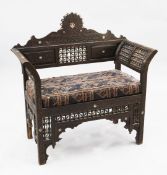 A Moorish window seat, profusely carved all-over with mother of pearl stellar motifs and