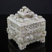 A Chinese archaistic burnt white and russet jade seal box and cover, the exterior profusely carved