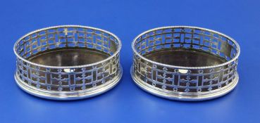A pair of George III pierced silver wine coasters by John Weldring?, with gadrooned border, engraved