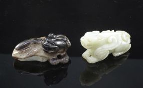 Two Chinese jade figures of mythical beasts, 19th century, the first scratching its head with a hind