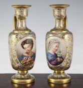 A pair of Bohemian enamelled and gilt decorated glass ewers, late 19th century, each painted to