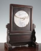 A Chinese rosewood and dreamstone inset table screen, late 19th / early 20th century, the circular