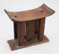 An African hardwood Ashanti stool, of traditional form, central column with chip carved and