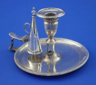 A George III silver chamberstick and snuffer, of circular form, with beaded border and engraved