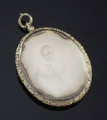 An oval Victorian daguerreotype mourning pendant, with chased gilt metal frame depicting a