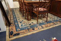 An early 20th century Peking carpet, with central foliate medallion in a field of flowers and