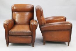 A pair of 1940's French brown leather upholstered club armchairs