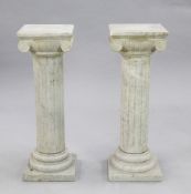 A pair of 19th century marble columns, with ionic capitals, circular bases and square plinths,