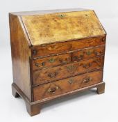 An 18th century walnut featherbanded bureau, the fall front with fitted interior above two short and