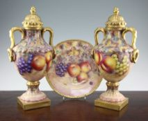 G. Delaney. A pair of fruit painted two handled Limoges porcelain vases and covers, late 20th