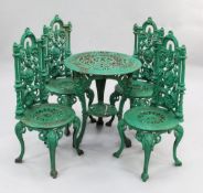 A set of four Victorian green painted cast iron garden chairs, the pierced backs with central