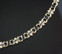An Indian 14ct gold, sapphire and diamond circular and baton link bracelet, set with oval, square