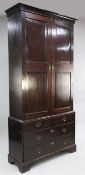 A George III mahogany bookcase, with fielded panelled doors over two short and two graduated long