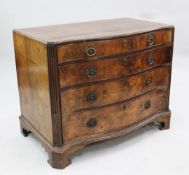 A George III mahogany serpentine chest, two long drawers above a single deep drawer modelled as