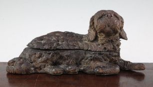 A late 19th / early 20th century Black Forest carved double inkwell, modelled as reclining dog,