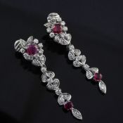 A pair of white gold, ruby and diamond cluster drop earrings, with foliate motifs and each set