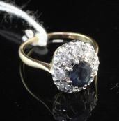 An 18ct gold and platinum, sapphire and diamond cluster ring, of oval form, size O.