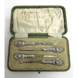 A CASED SILVER FOUR PIECE MANICURE SET with loaded Art Nouveau handles to steel fittings