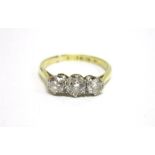 A THREE STONE DIAMOND RING stamped '18ct Plat', the graduated brilliant cuts totalling approximately