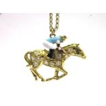 AN 18CT GOLD DIAMOND AND ENAMEL JOCKEY AND RACEHORSE PENDANT the galloping horse set with ten