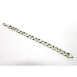 A SILVER BRACELET  of solid filed curb links, 22.5cm long, 63g gross