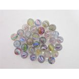 THIRTY-THREE LATE 19TH & EARLY 20TH CENTURY HAND-MADE MARBLES all swirls, some with lattice cores,