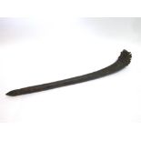 A HARDWOOD CLUB probably late 19th century, the curved head set with hand-made nails, 65cm long.