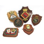 FIVE ROYAL NAVY CAST METAL SHIP'S TAMPIONS & BADGES including those for H.M.S. Tamar, H.M.S.