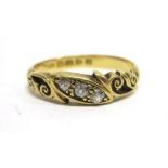 A LATE VICTORIAN THREE STONE DIAMOND 18CT GOLD RING Chester 1901, the graduated small old cuts to