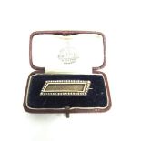 A VICTORIAN HAIR PANEL MOURNING BROOCH with a border of split pearls (untested and unwarranted), 4.